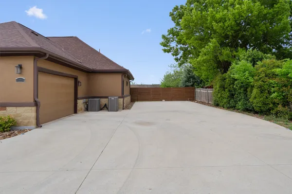 a view of empty room with tree and wooden fence