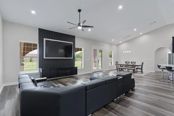 a living room with hard wood flooring and furniture