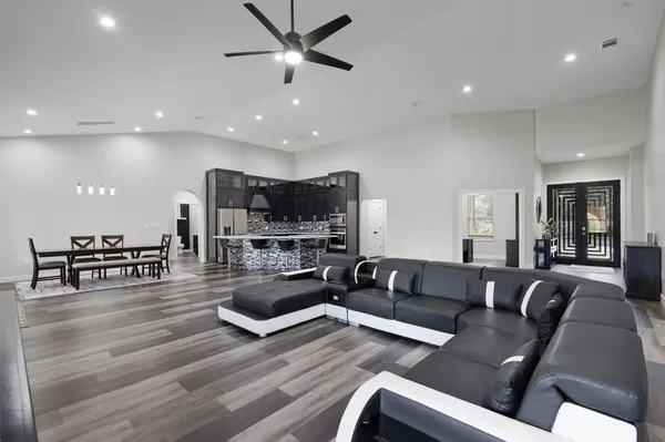 a living room with furniture and a wooden floor