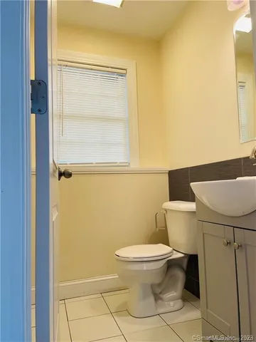 a white toilet sitting next to a bathroom sink