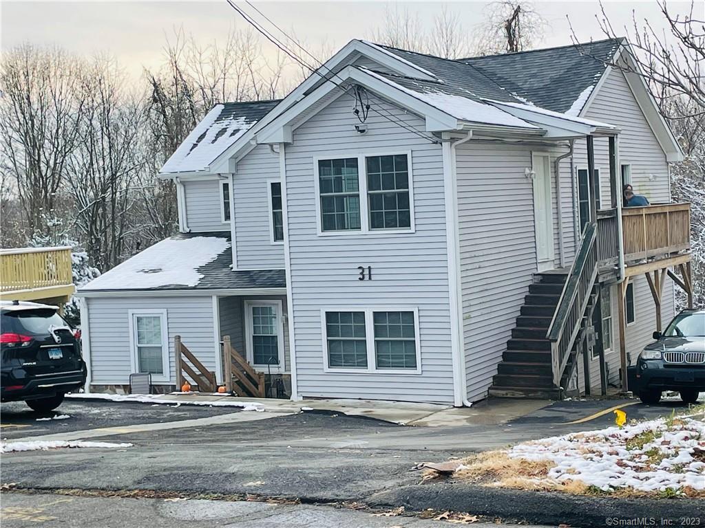 31 Brainerd Road, Unit 1 Branford, CT 06405 - Photo 17 of 17 a view of a house with a yard and large tree