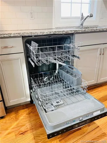 a view of a living room with a table and chairs
