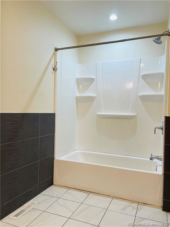 31 Brainerd Road, Unit 1 Branford, CT 06405 - Photo 9 of 17 a bathroom with a bathtub and a shower
