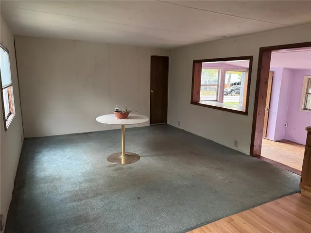 a room with a wooden floor and a window