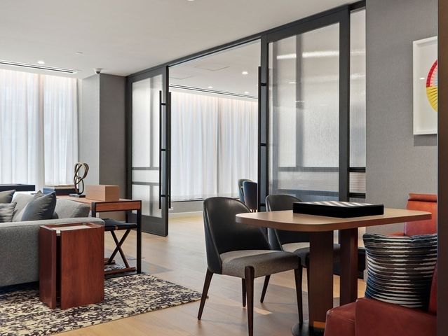 a living room with furniture and large windows