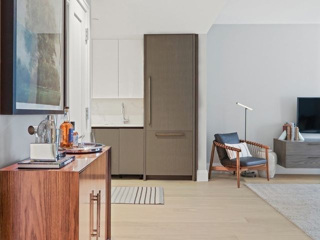 a kitchen with a sink cabinets and wooden floor
