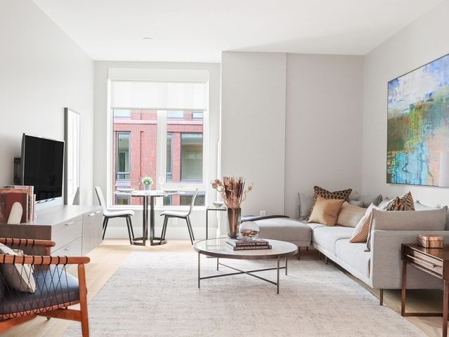 a living room with furniture wooden floor and a flat screen tv