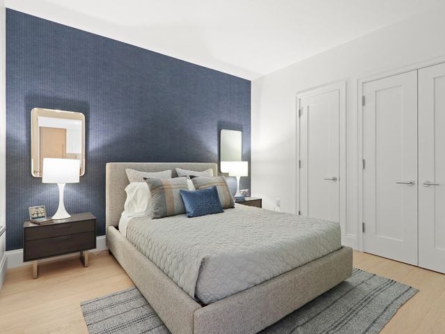 a bedroom with a bed and a lamp