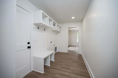 a view of a hallway with wooden floor