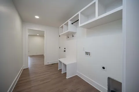 a view of a hallway with wooden floor