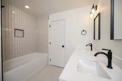 a bathroom with a sink a tub and a shower