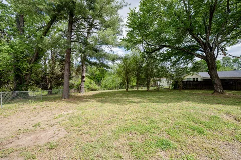 a view of a field with trees