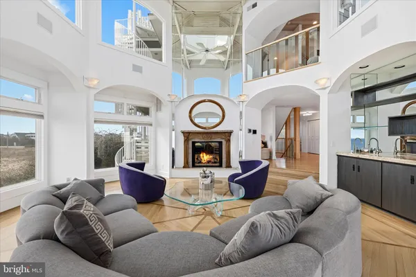 a dining room with furniture a mirror and kitchen view