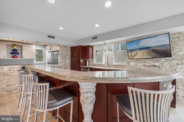 a large spacious bathroom with a granite countertop double vanity sink a mirror and a shower