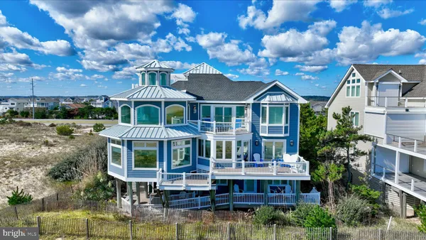 a view of a dry yard with wooden fence