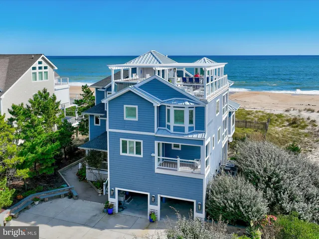 a front view of a building with lot of trees