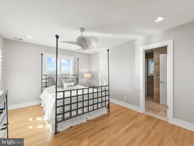 a spacious bathroom with a granite countertop shower a sink and a mirror