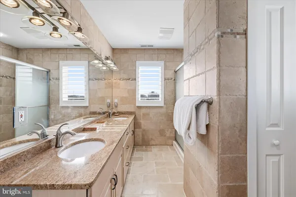 a en suite bathroom with a sink and a shower