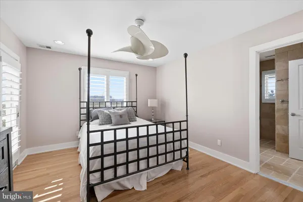 a bathroom with a granite countertop shower a sink and a mirror