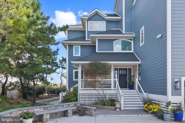 a living room with furniture a clock and a fireplace