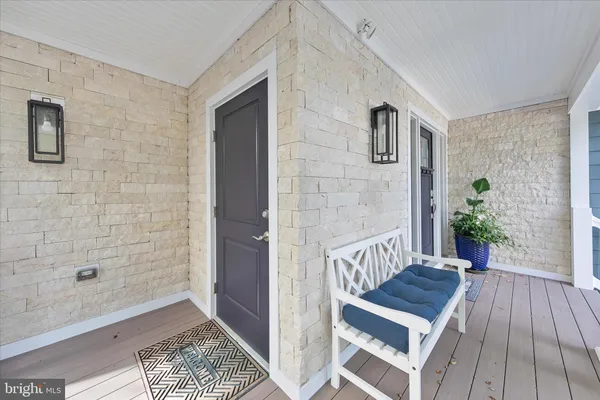 a view of a dining area with stainless steel appliances kitchen island granite countertop a dining table chairs and granite counter tops