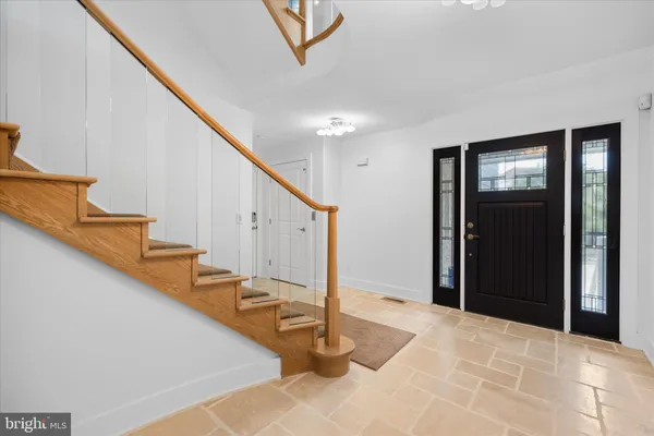 a kitchen with stainless steel appliances granite countertop table chairs sink and cabinets