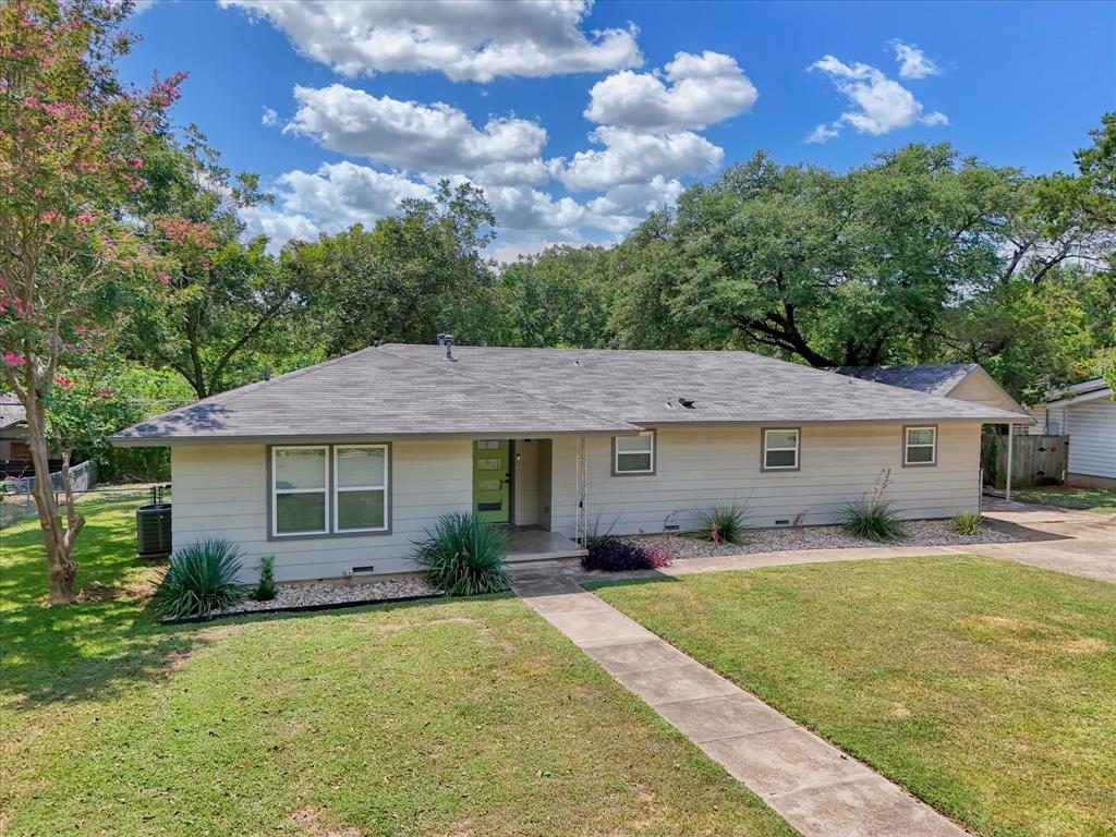4600 Cedar Mountain Drive Waco, TX 76708 - Photo 1 of 33 a front view of a house with a garden and trees