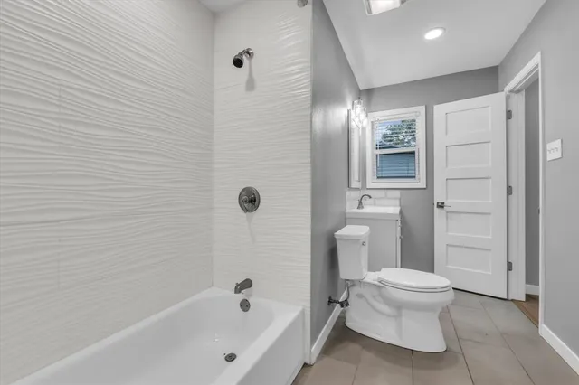 a bathroom with a toilet and shower