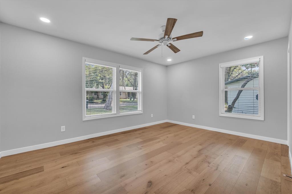 4600 Cedar Mountain Drive Waco, TX 76708 - Photo 17 of 33 a view of a big room with wooden floor and windows