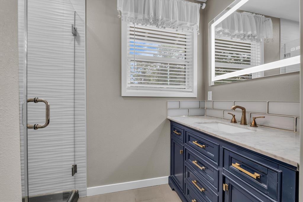 4600 Cedar Mountain Drive Waco, TX 76708 - Photo 20 of 33 a bathroom with a granite countertop sink and a window