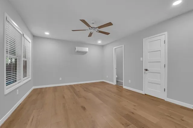 wooden floor in an empty room with a window