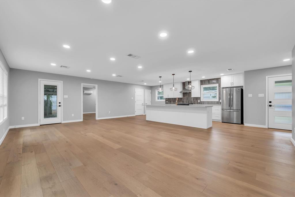 4600 Cedar Mountain Drive Waco, TX 76708 - Photo 24 of 33 a view of a kitchen with a sink and dishwasher a refrigerator with wooden floor