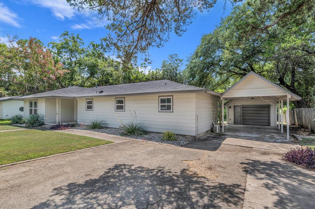 4600 Cedar Mountain Drive Waco, TX 76708 - Photo 4 of 33 a view of a yard in front of a house with large tree