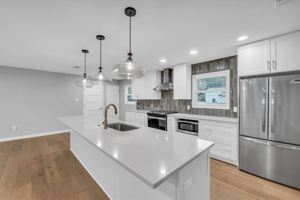 4600 Cedar Mountain Drive Waco, TX 76708 - Photo 7 of 33 a kitchen with stainless steel appliances granite countertop a sink a refrigerator and a stove top oven