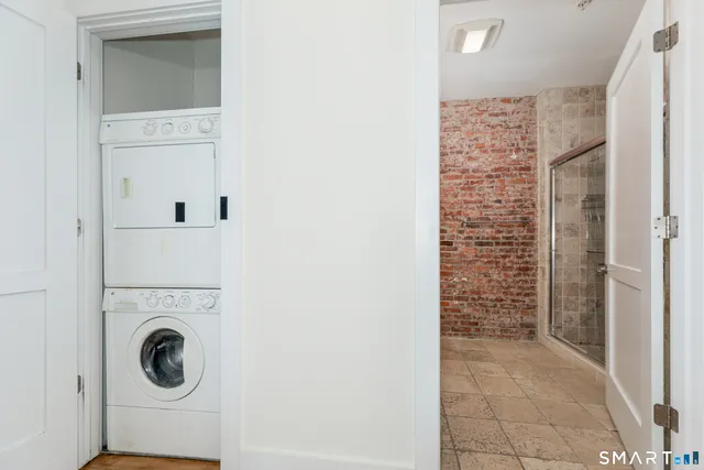 a view of empty room with window and hardwood floor