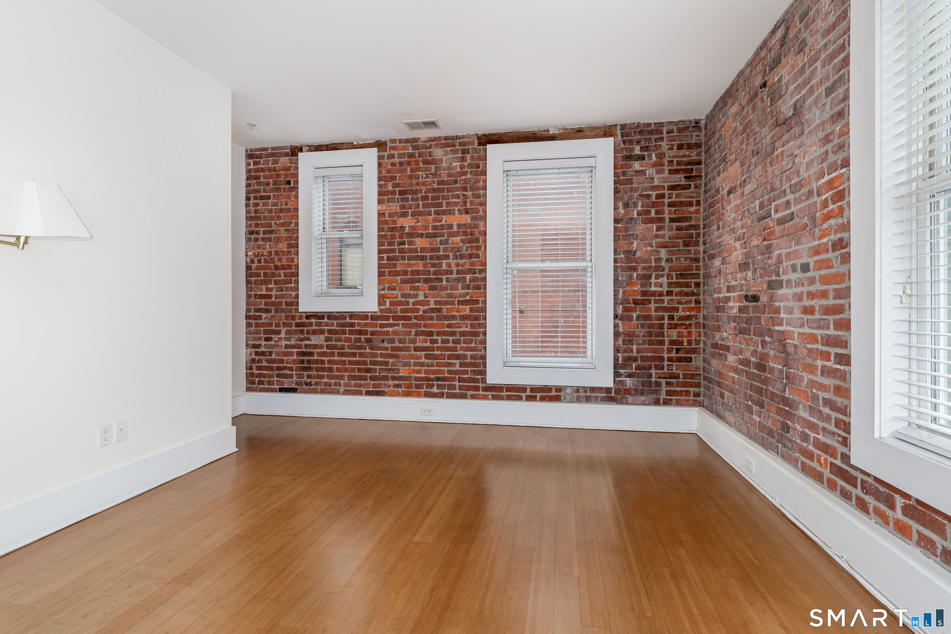 116 Crown Street, Unit 2A New Haven, CT 06510 - Photo 9 of 12 a view of an empty room with wooden floor and a window