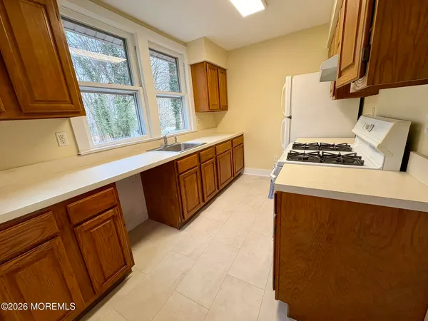 a kitchen with stainless steel appliances a stove a refrigerator white cabinets and a refrigerator