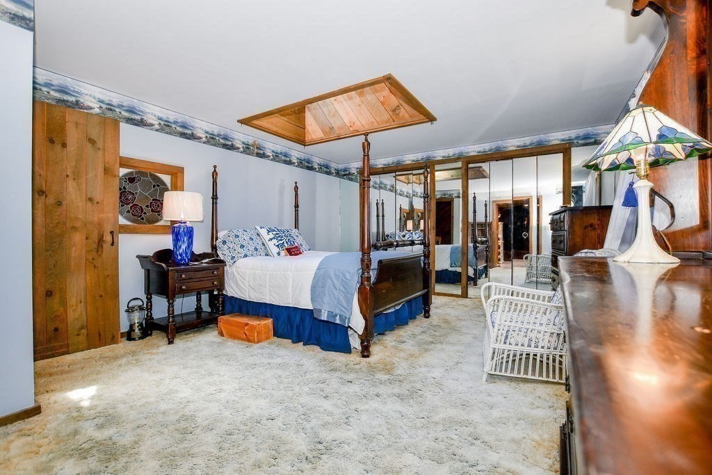 30 Clark Road Bourne, MA 02562 - Photo 25 of 40 a bedroom with a bed a rug and a chandelier