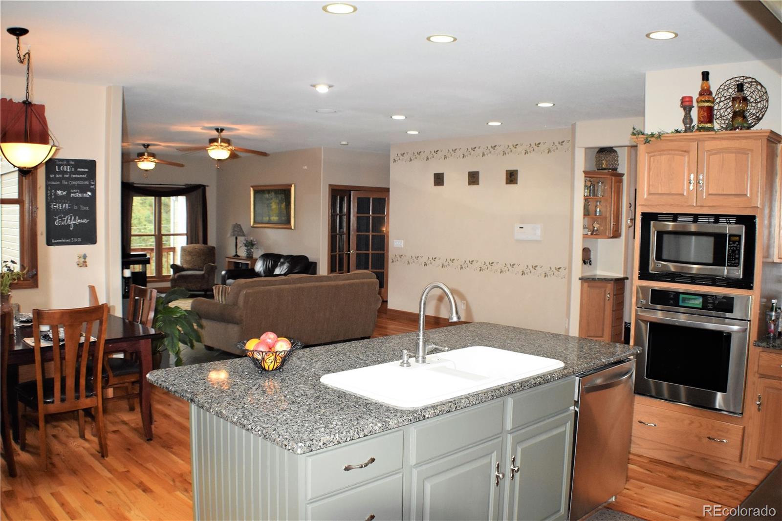 2355 Bricker Road Monument, CO 80132 - Photo 6 of 35 a kitchen with stainless steel appliances granite countertop a sink a stove and a refrigerator