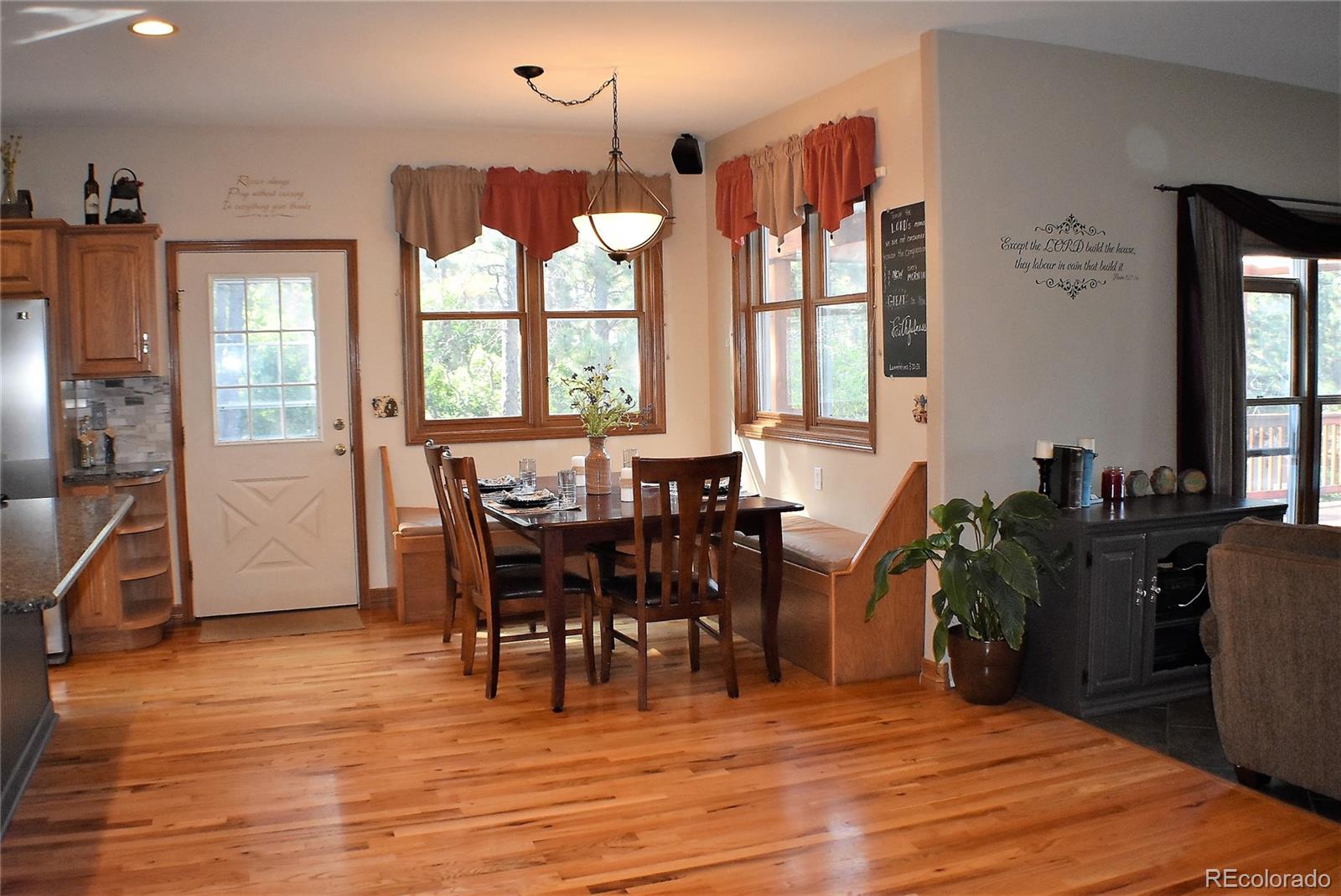 2355 Bricker Road Monument, CO 80132 - Photo 7 of 35 a view of a dining room with furniture window and wooden floor