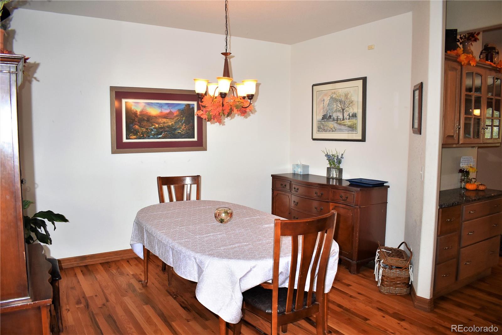 2355 Bricker Road Monument, CO 80132 - Photo 9 of 35 a view of a dining room with furniture wooden floor and a chandelier