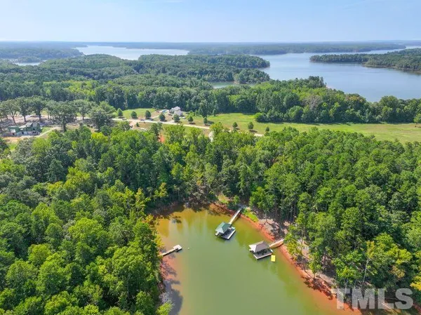an aerial view of lake residential house with outdoor space and trees around