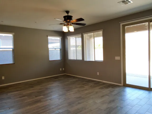 an open kitchen with kitchen island a sink dishwasher a stove and a refrigerator with wooden floor