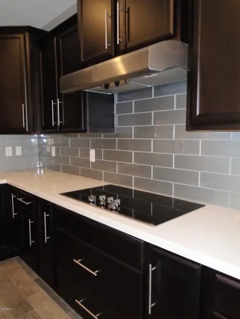 a kitchen with stainless steel appliances granite countertop a sink a refrigerator and a stove