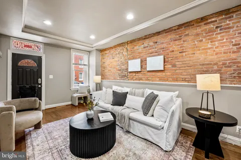 a living room with furniture and a lamp