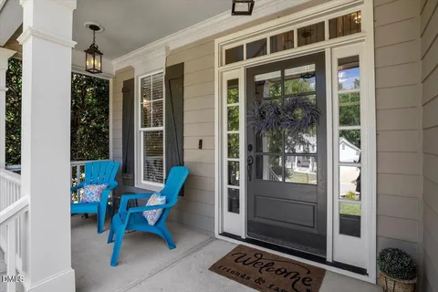 a view of a porch with a table and chairs