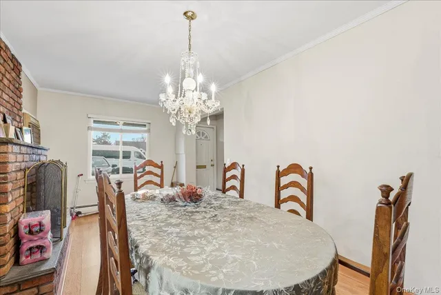a view of a dining room with furniture and a chandelier