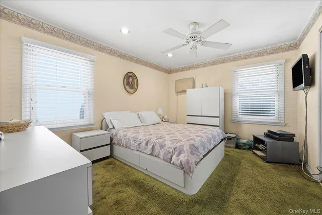 a spacious bedroom with a bed and a chandelier