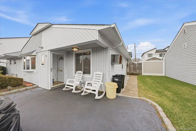 a view of a patio with table and chairs and a barbeque
