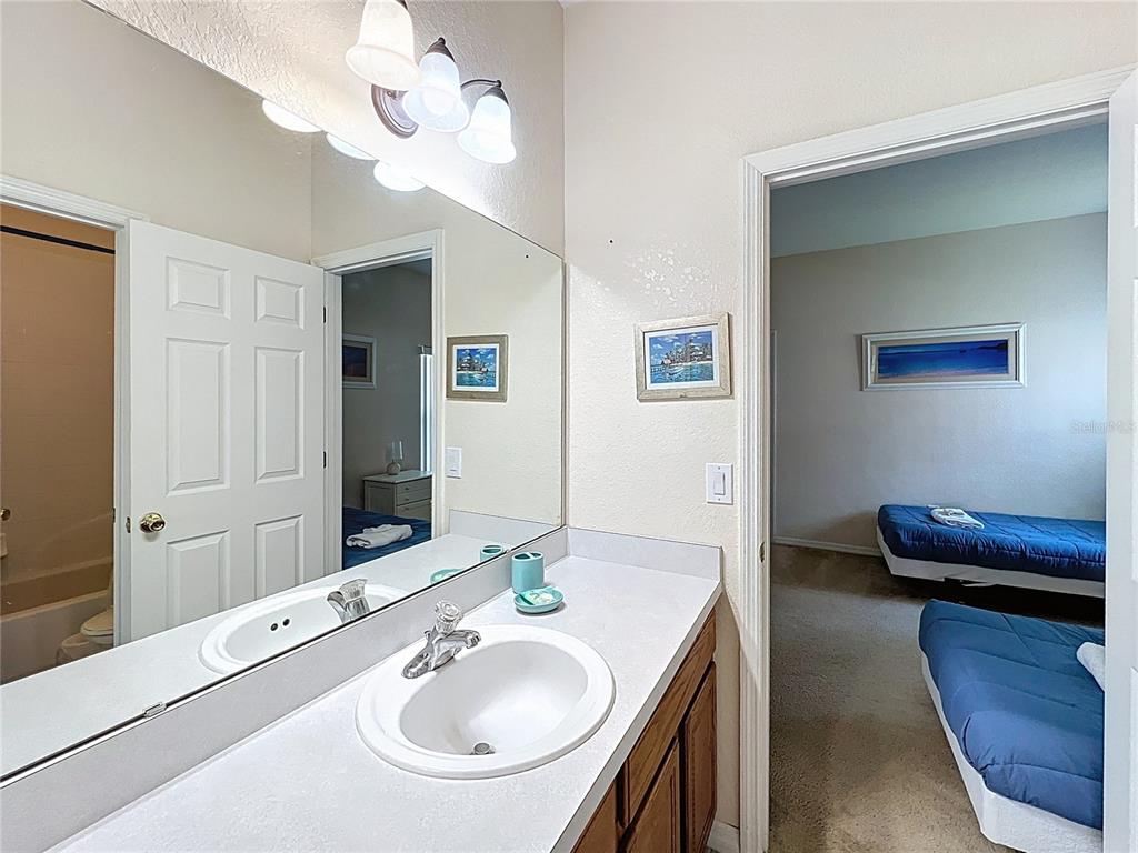 102 Sandy Point Way Clermont, FL 34714 - Photo 19 of 33 a bathroom with a sink and a mirror
